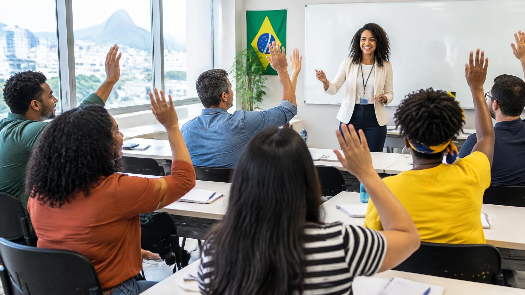 Bright classroom with adults raising hands during a course